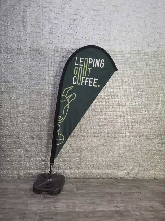 Feather banner outside a cafe showcasing coffee specials – Custom advertising flags to attract customers and boost brand visibility for coffee shops