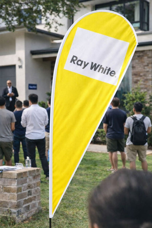 Real estate auction signage featuring custom teardrop banners and flag banners