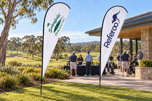 AI mockup of Sunnyfield Charity Golf Day and Referoo teardrop banners beside a golf clubhouse registration area.