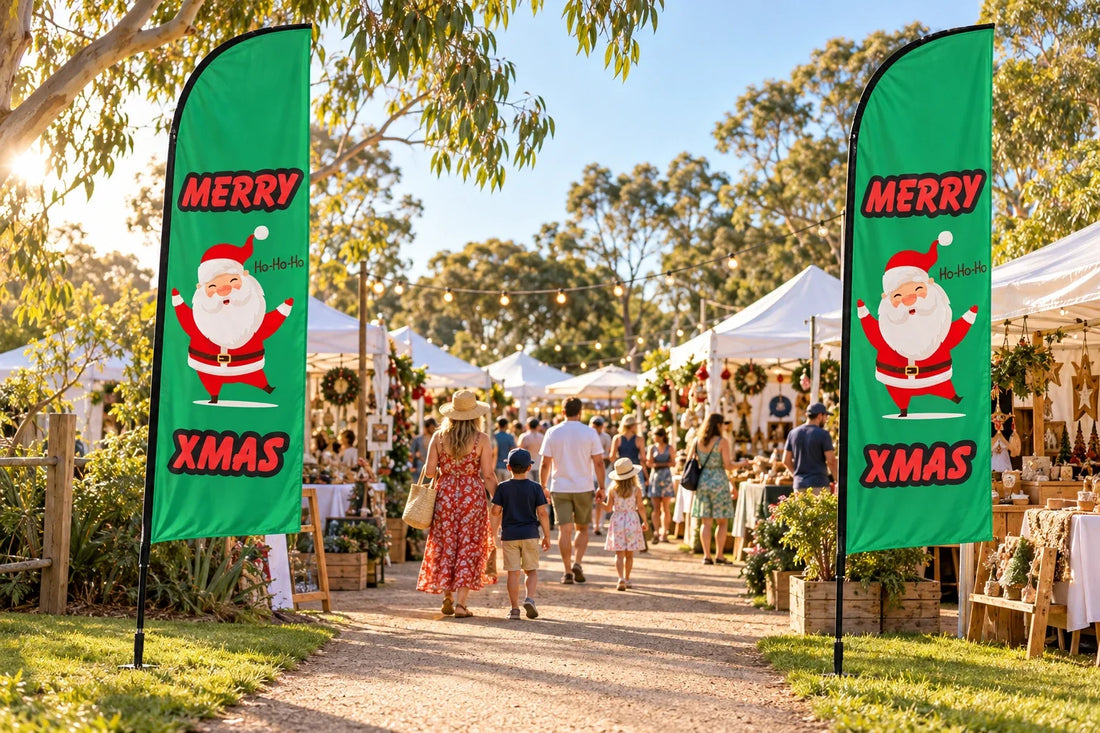 Green Merry Xmas feather flags with Santa artwork beside the entrance to an Australian Christmas market, shown in an mockup.