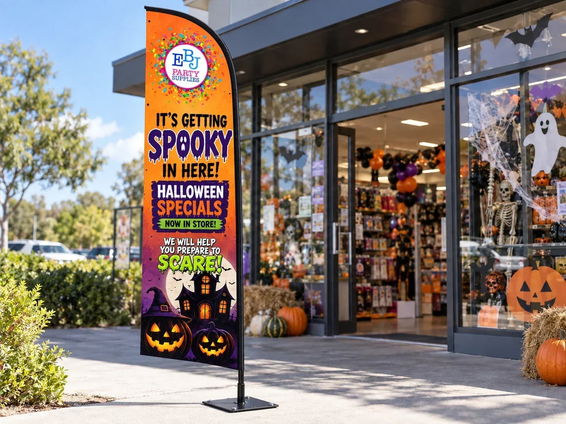 EBJ Party Supplies Halloween feather banner outside a shop, with orange artwork and purple Spooky lettering.