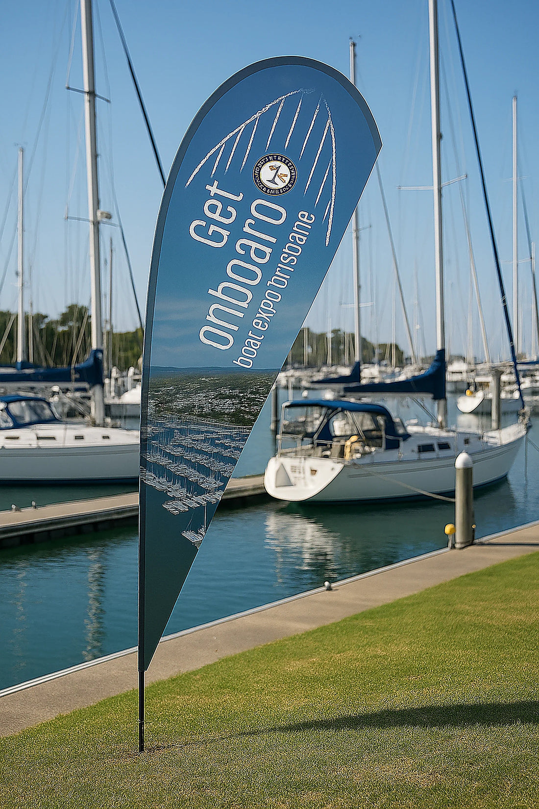 Teardrop banner displayed at marina dock for Royal Queensland Yacht Squadron sailing event