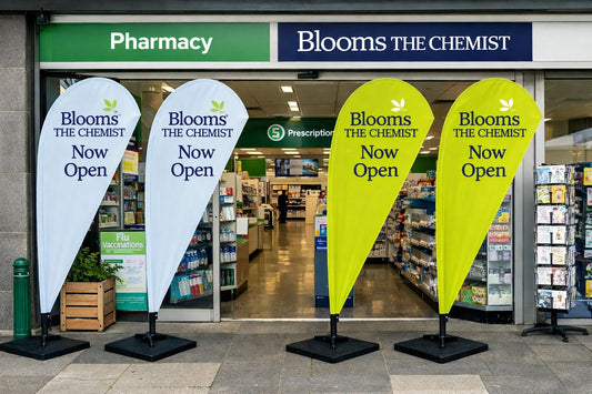 Pharmacy storefront teardrop banners attracting foot traffic Australia