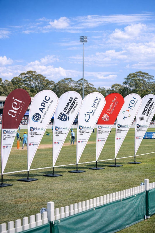 Custom teardrop banners for universities at a cricket match in Sydney
